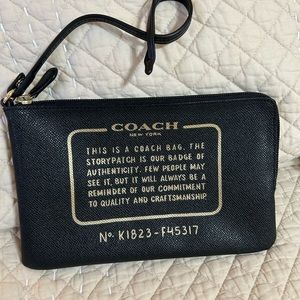 Black Coach cosmetic bag. Tether for the inside of your bag.
